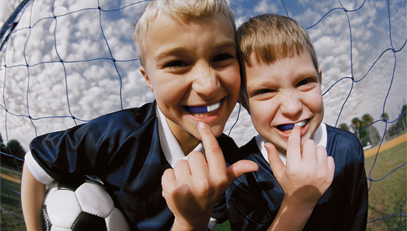 Portrait of two boys showing their missing teeth