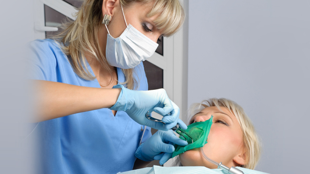 Dentist treating patient